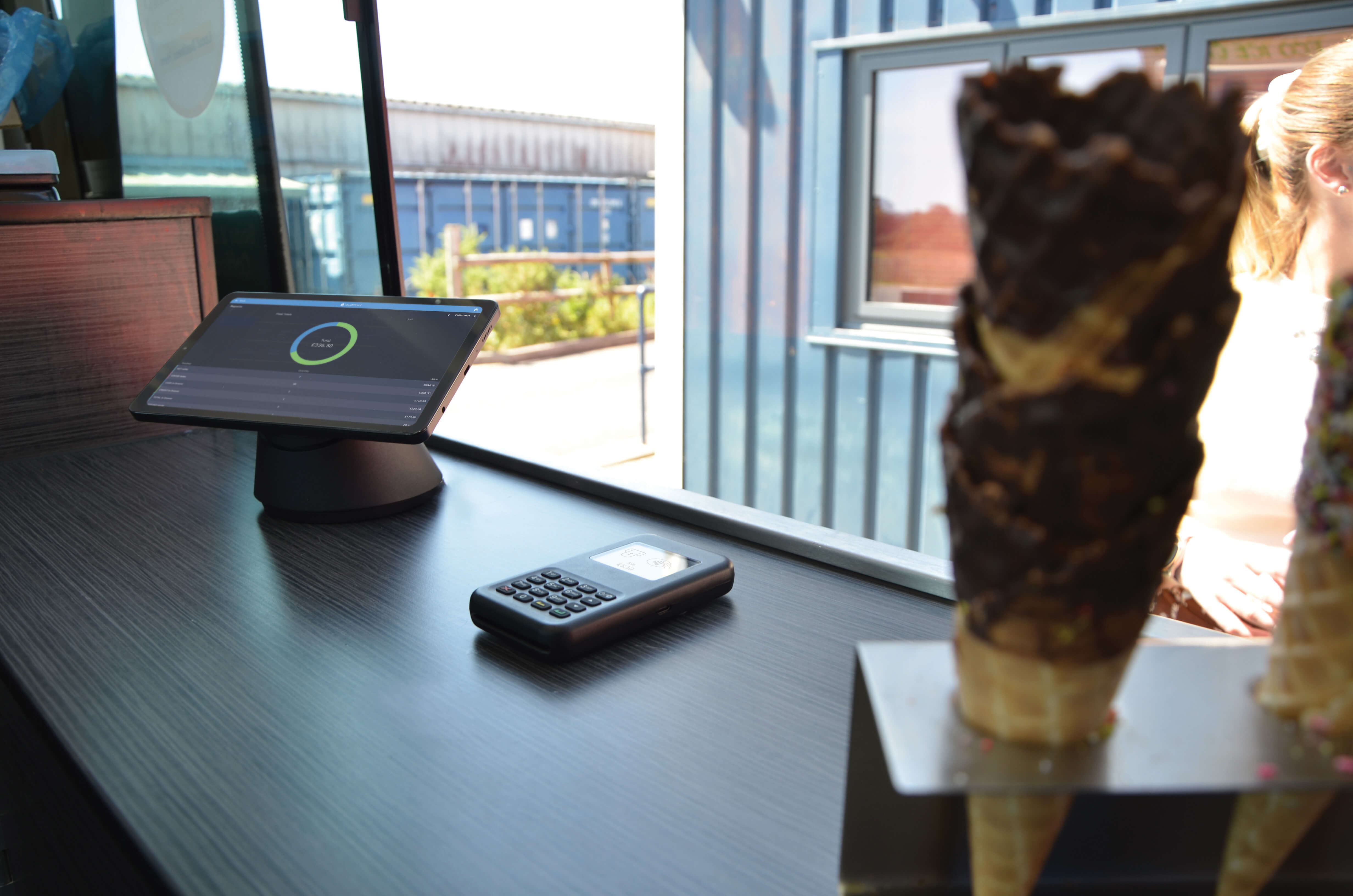 An image of a tablet with Touchpoint Lite installed, integrated card reader being used on a Ice Cream stand